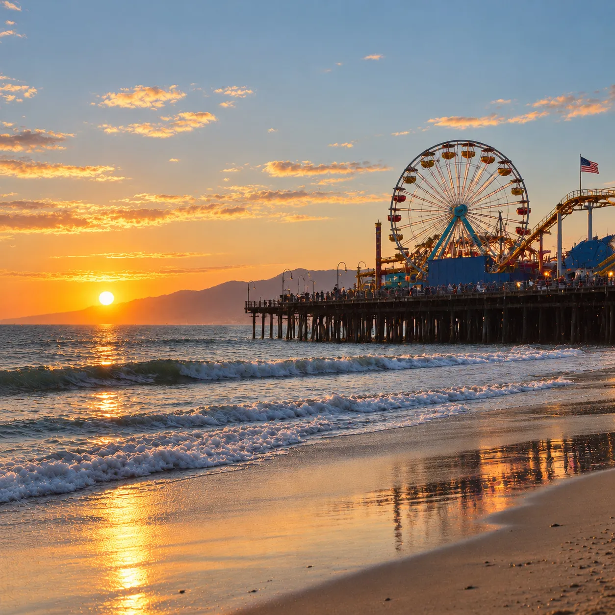 The Santa Monica Pier Ferris wheel at sunset, seen from the beach